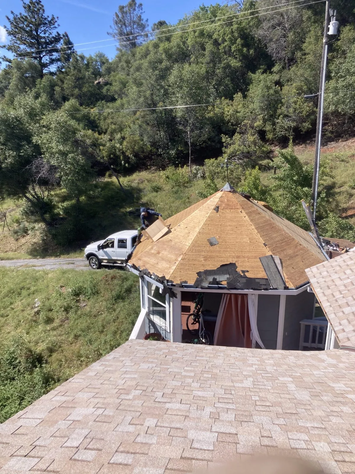 Shingle tear-off and roof re-deck in progress
